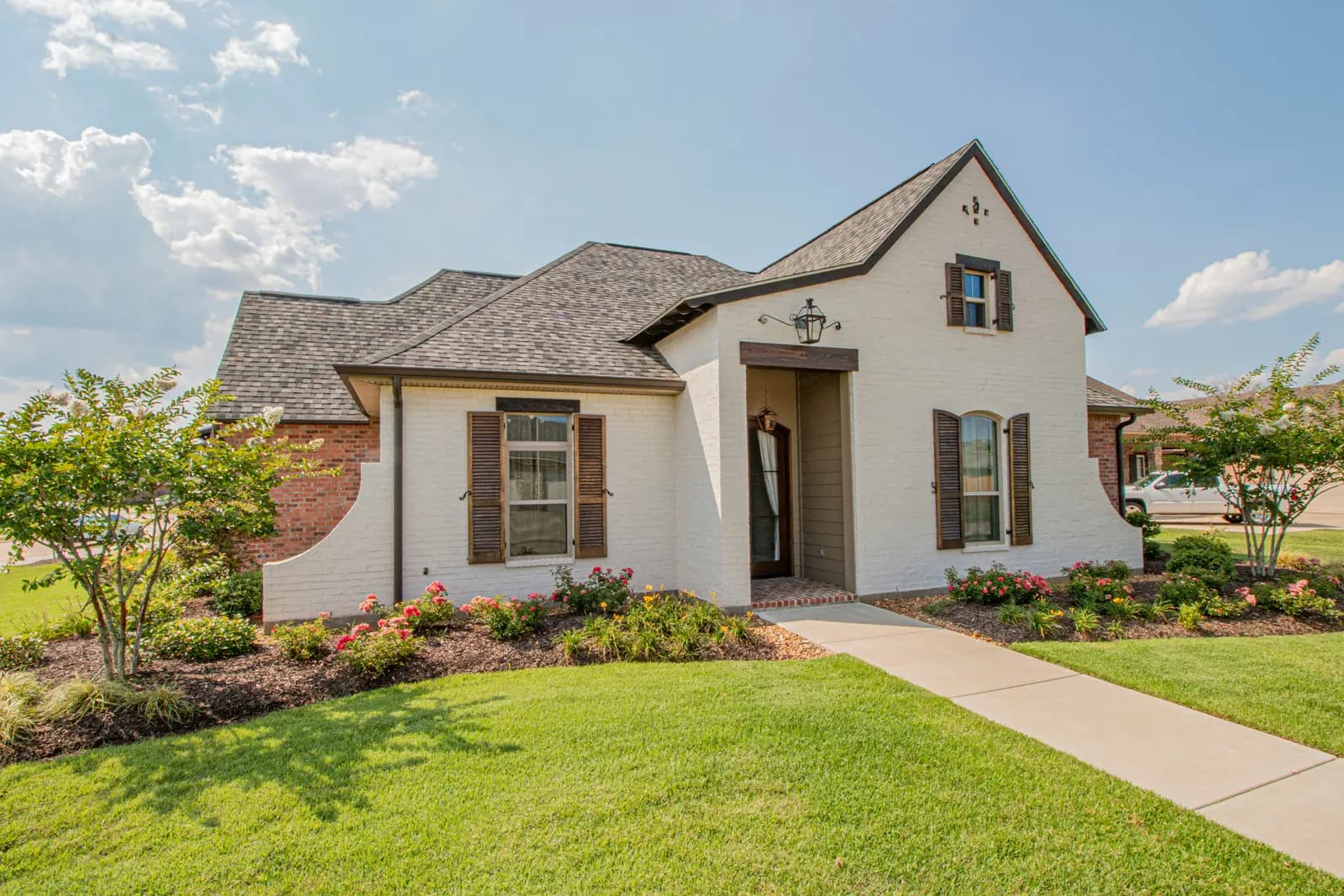 Finished suburban home exterior with a manicured lawn
